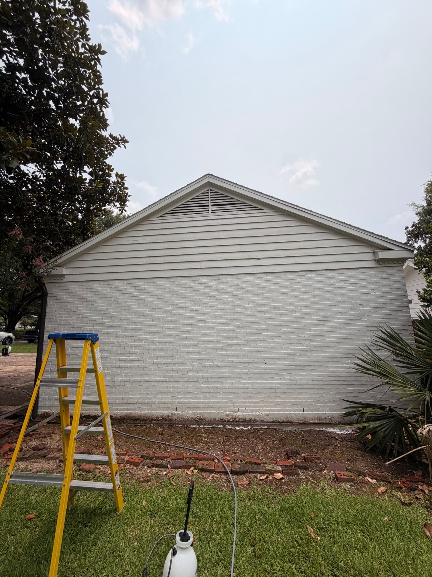 Same painted brick and siding gable bright white after cleaning